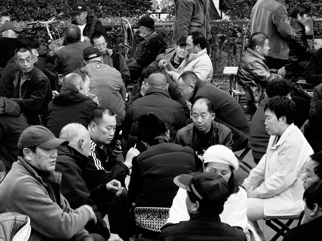Large group of smiling seniors gathered together at a community meeting