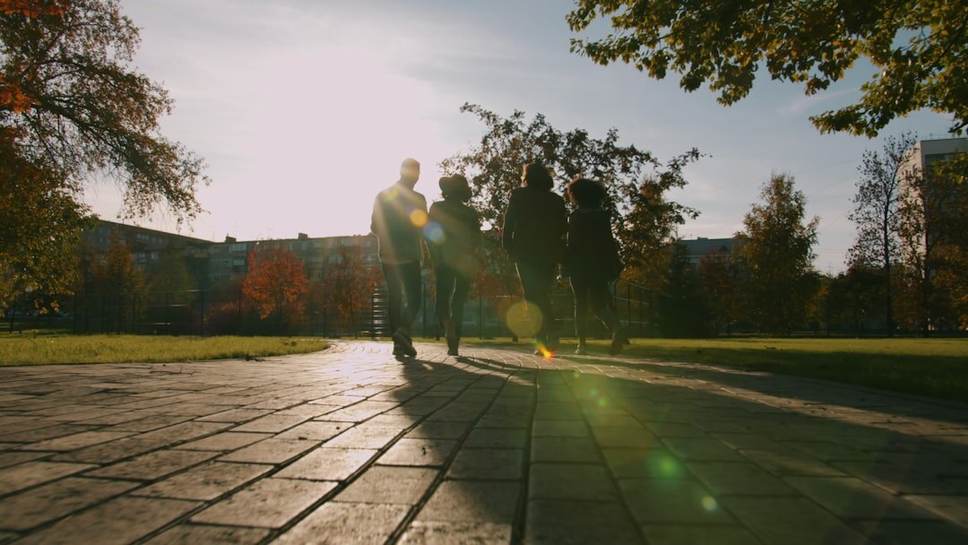 Group of active senior friends walking and laughing together in a park